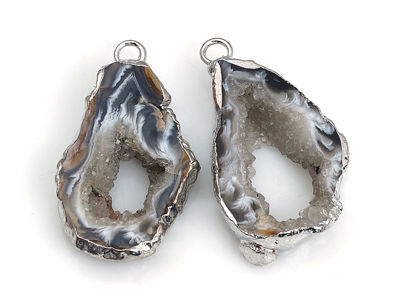 Пара подвесок срезов жеод морозного агата в оправе цвета "серебро". Месторождение - Бразилия. Подвес - 2 мм. Размеры и вес усреднены. Мелкие выемки.

